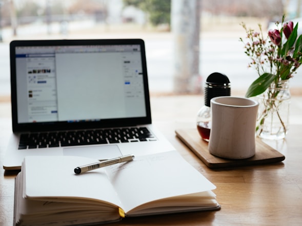 Laptop with coffee cup on desk workspace